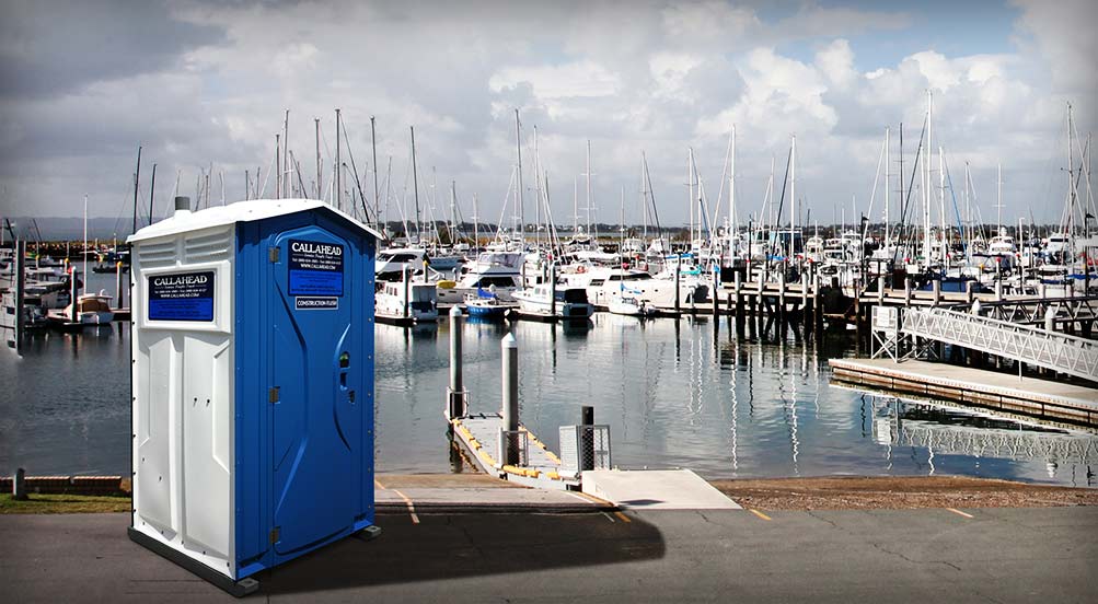The Blue And White Construction Flush Portable Toilet By The Docks