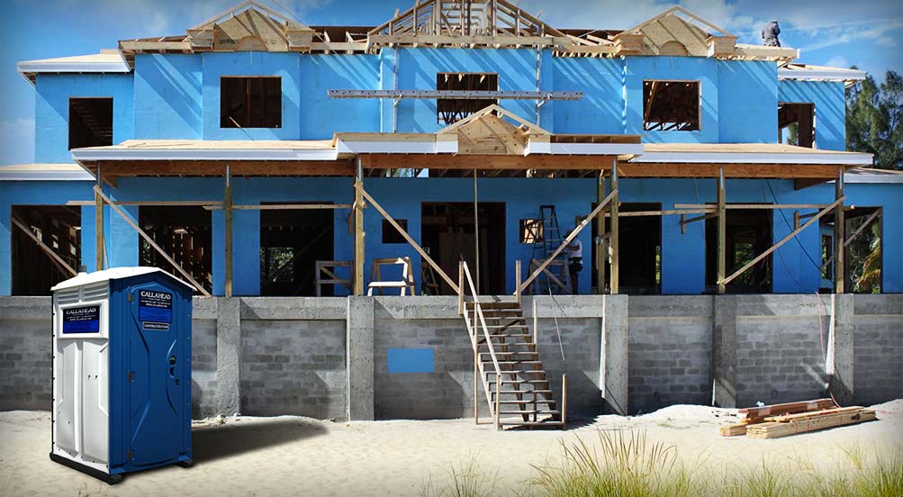 The Blue And White Construction Flush Portable Toilet Near Residential Construction