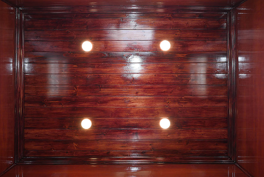 WOOD FINISH CONTINUES ON THE CEILING, SHOWN HERE WITH LED LIGHTING