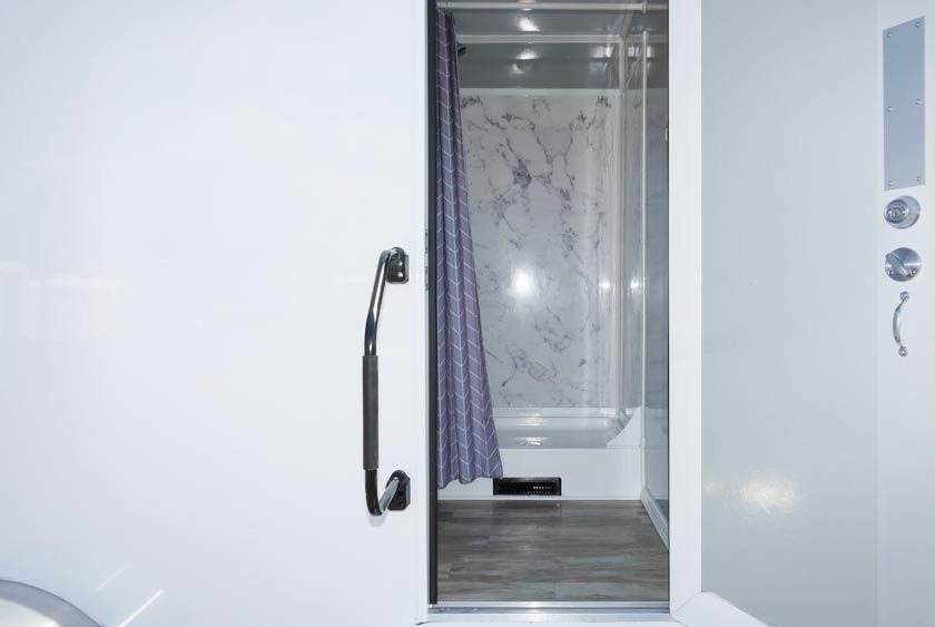 ENTRANCE TO THE FOGHORN SHOWER TRAILER HAS SECURE HANDRAIL FOR SAFETY