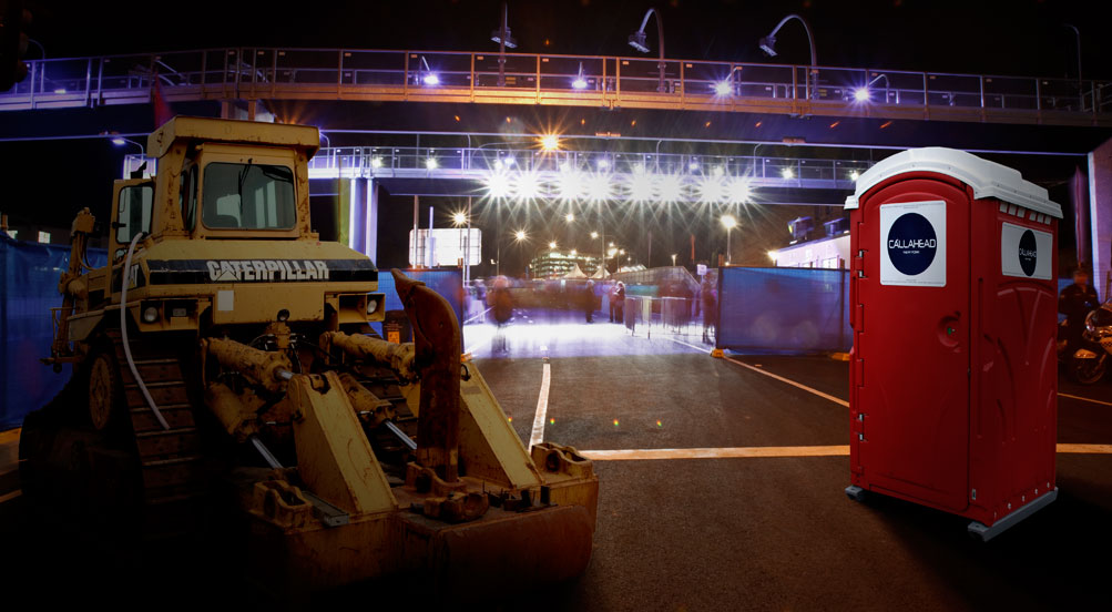 The Red Head Portable Toilet Near Bridge Construction