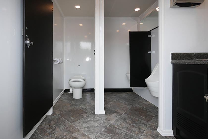 TWO URINALS AND ONE PRIVATE BATHROOM STALL ON MEN'S SIDE