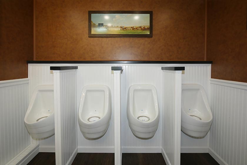 FOUR PORCELAIN URINALS WITH PRIVACY DIVIDERS