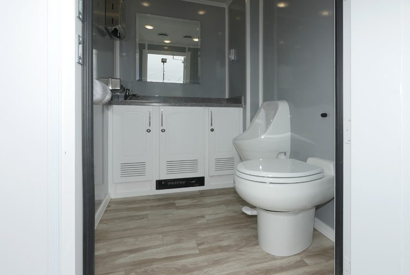 ENTRANCE TO MEN'S SIDE OF THE BLUE STEEL RESTROOM TRAILER