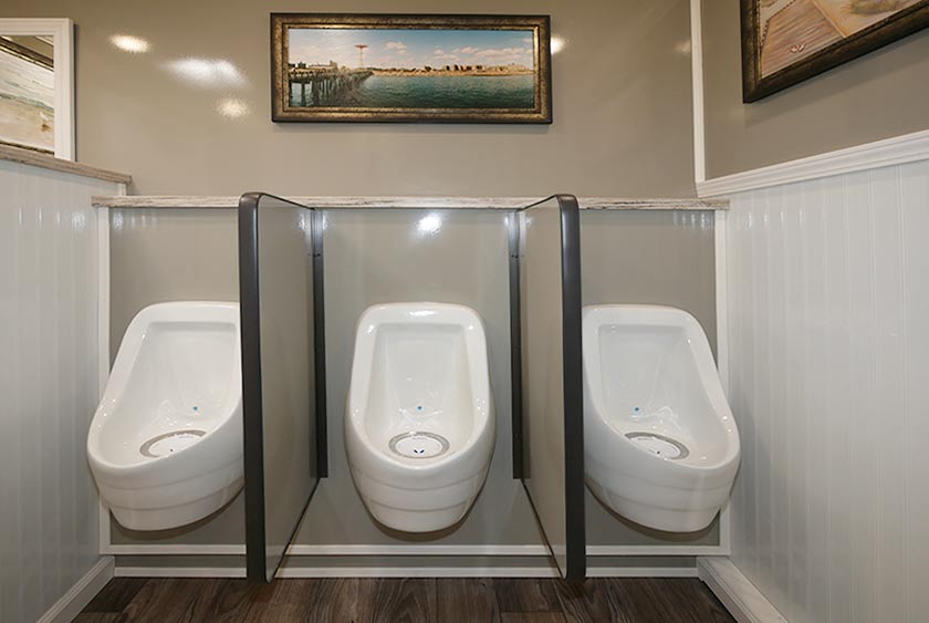THREE ODORLESS PORCELAIN URINALS INSIDE MEN'S ROOM