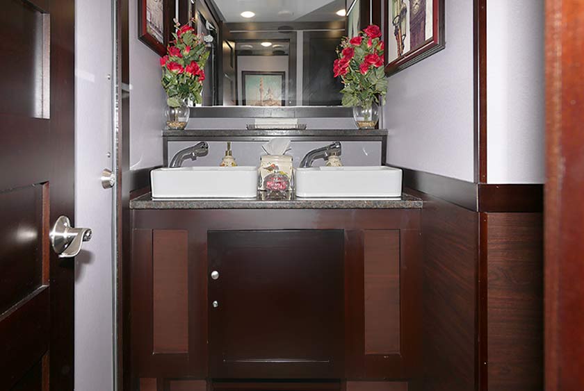 WOOD VANITIES WITH CORIAN COUNTERTOPS AND LARGE MIRRORS