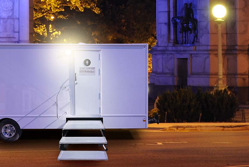 TER THE RESTROOM TRAILER VIA HEAVY DUTY WIDE STEPS WITH ALUMINUM AND STEEL FRAMES, AND EXTERIOR LIGHTING