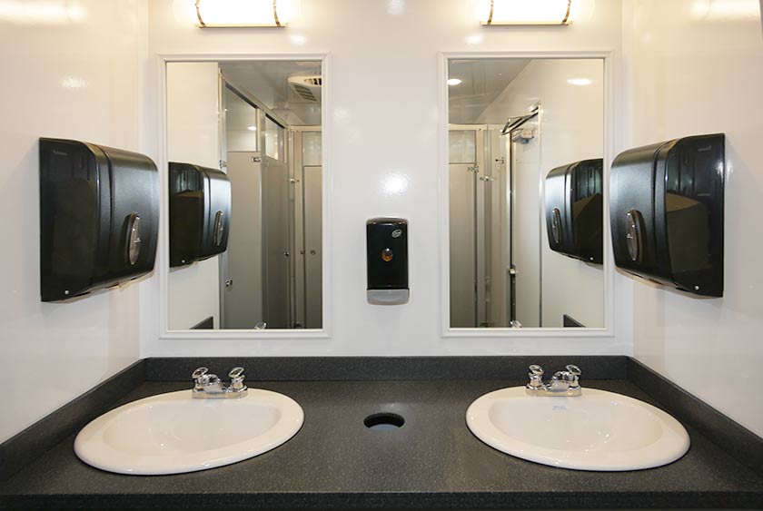 FOUR WALL MOUNTED FILLED TWO-FOLD HAND TOWEL DISPENSERS (TWO MEN’S AND TWO WOMEN’S) 