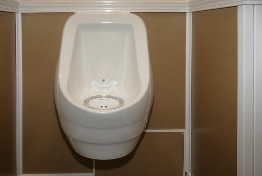 SLOAN PORCELAIN WATERLESS URINAL ON MEN'S SIDE