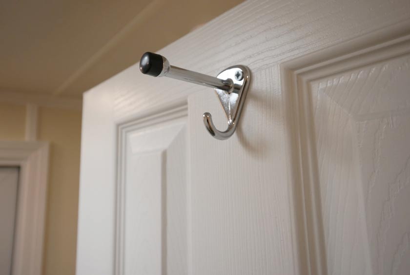 CONVENIENT COAT AND HAT HOOKS INSIDE TOILET STALLS