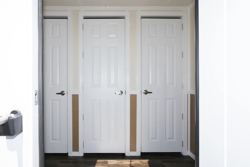 WOMEN'S SIDE HAS THREE PRIVATE BATHROOM STALLS