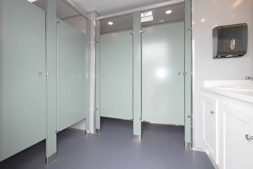 WOMENS' ENTRANCE AND FOYER LEADS TO 4 PRIVATE BATHROOM STALLS