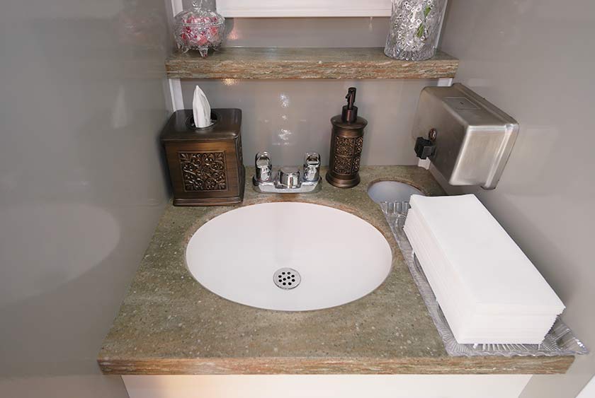 MARBLE COUNTERTOPS WITH PORCELAIN SINKS AND AUTOMATIC SHUTOFF FAUCETS