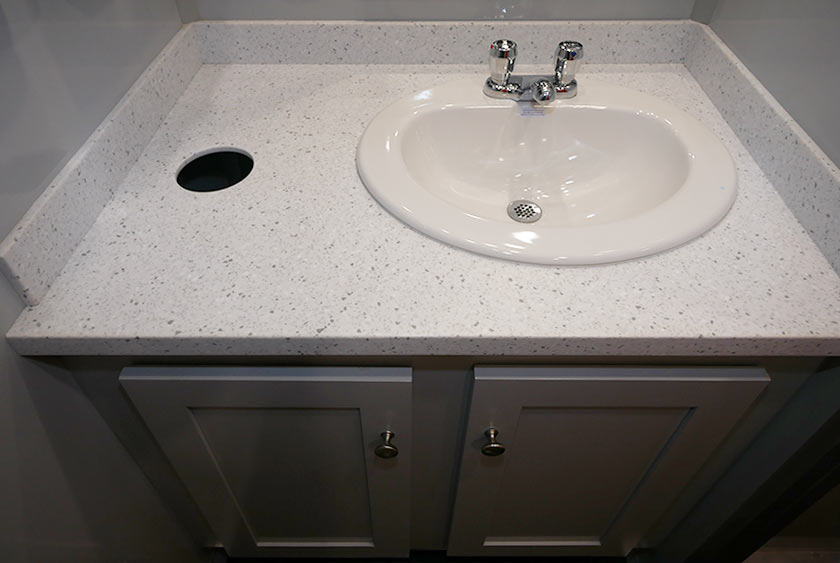 VANITY WITH CORIAN COUNTERTOP, PORCELAIN SINK AND TRASH RECEPTACLE