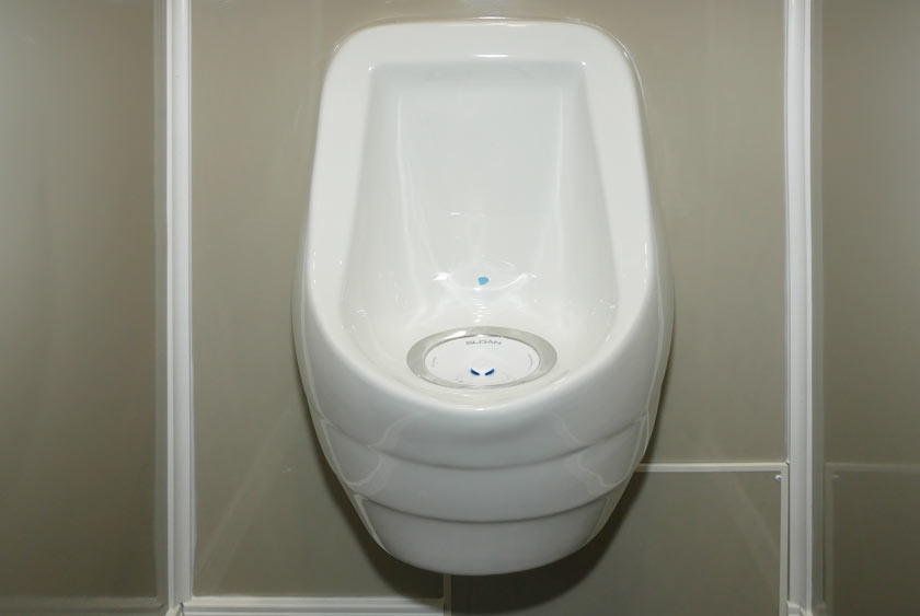 SLOAN PORCELAIN WATERLESS URINAL ON MEN'S SIDE