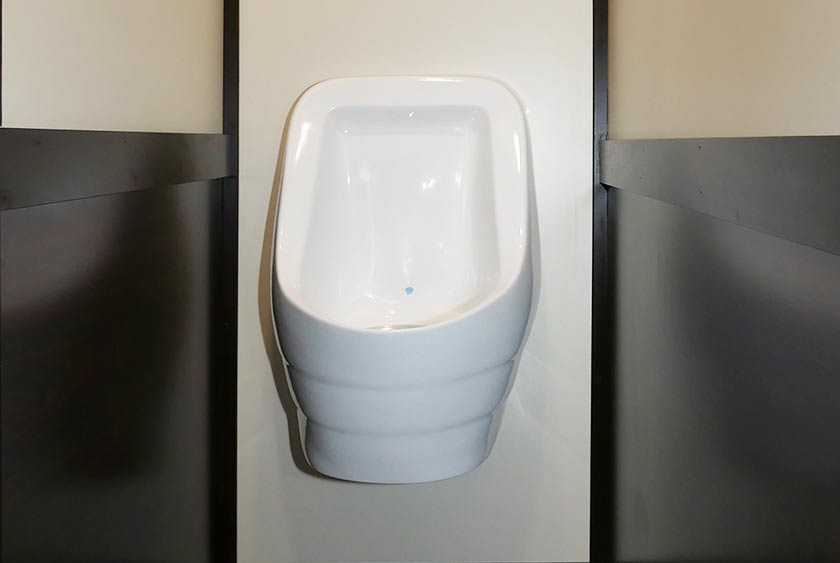 SLOAN PORCELAIN URINAL ENCLOSED ON 3 SIDES FOR PRIVACY