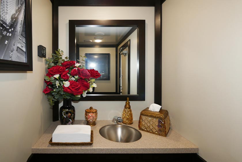 VANITY AREA WITH WOOD FRAMED MIRROR