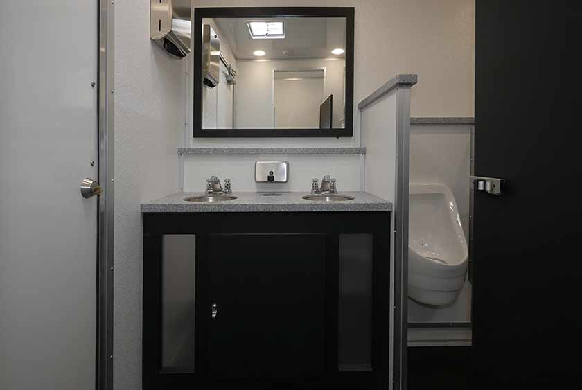 BATHROOM VANITIES HAVE LARGE MIRRORS OVER THE SINKS