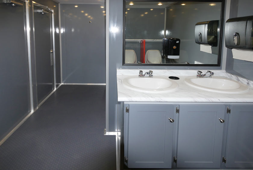 SINK VANITY WITH LARGE MIRROR IN EACH RESTROOM