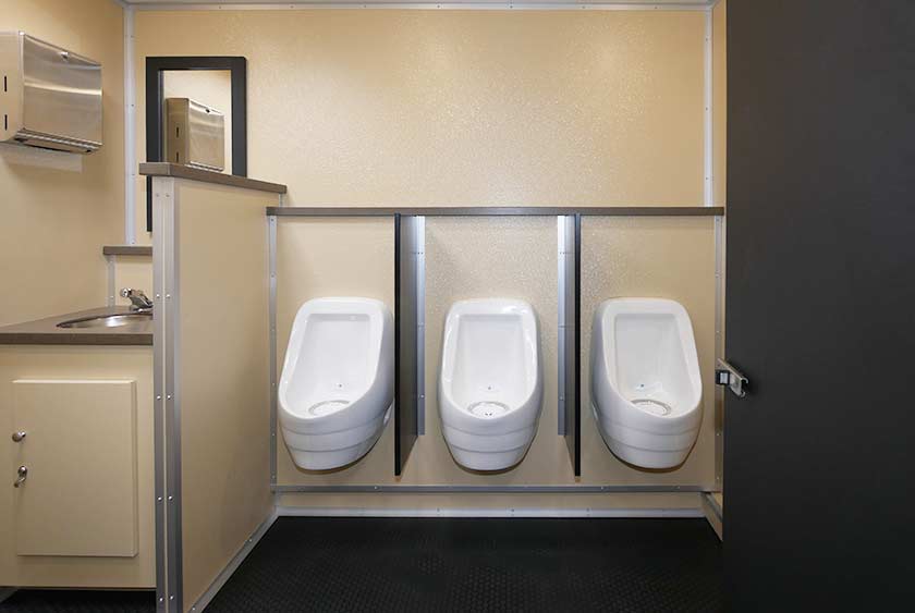 MEN'S SIDE HAS A SINGLE VANITY WITH SINK, THREE URINALS AND TWO PRIVATE STALLS