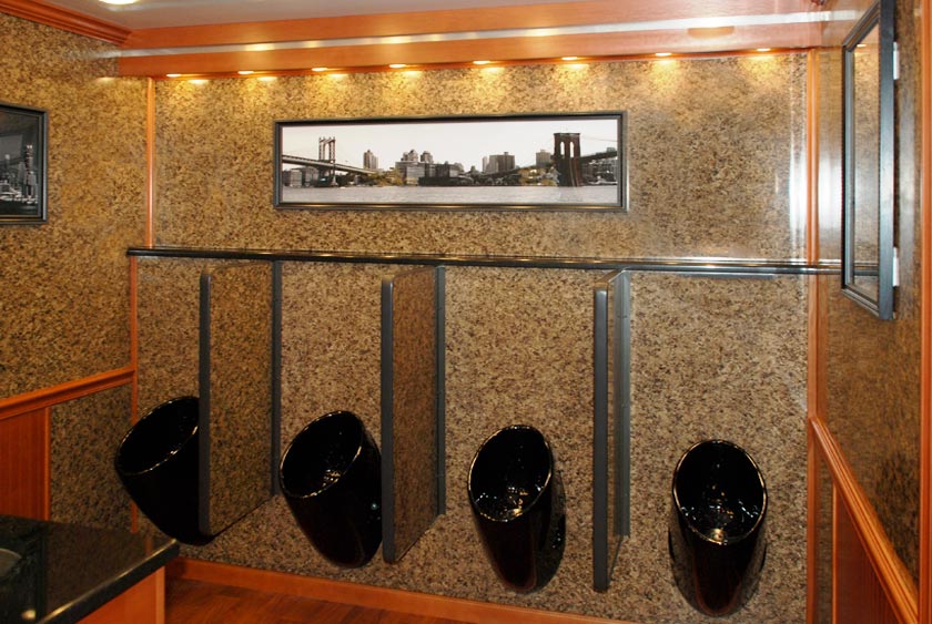 FOUR BLACK PORCELAIN URINALS WITH PRIVACY DIVIDERS