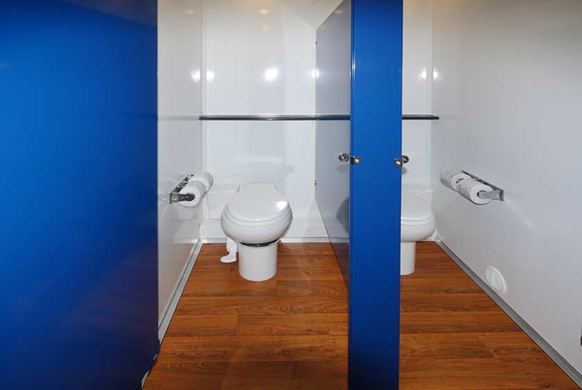 TWO PORCELAIN TOILETS ON WOMEN'S SIDE