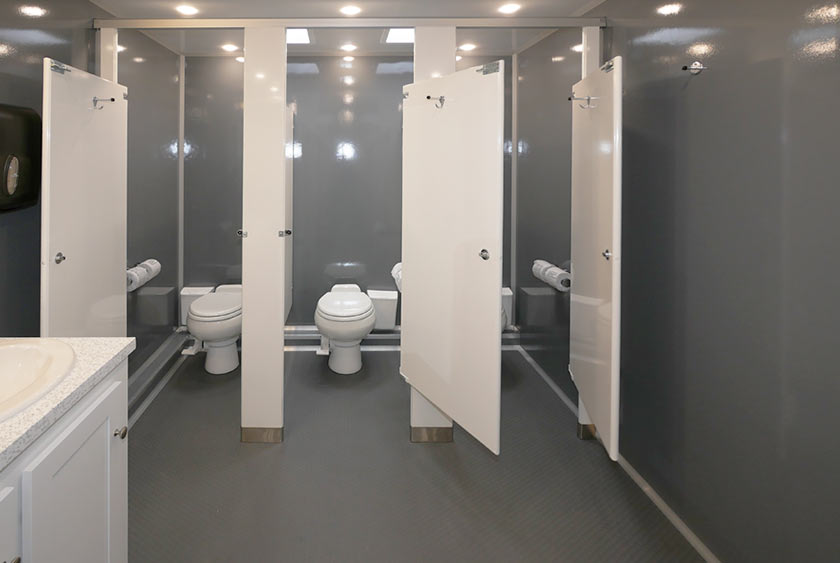 THREE OF THE SIX TOILET STALLS IN LADIES ROOM