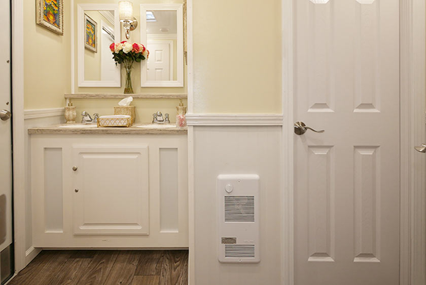 WOMEN'S SIDE VANITY AND 1 OF 4 BATHROOM STALLS