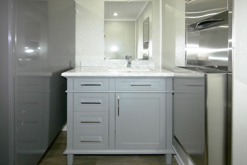 GOLD LEAF WOOD-FRAMED ARTWORK IN TOILET STALLS AND VANITY AREAS